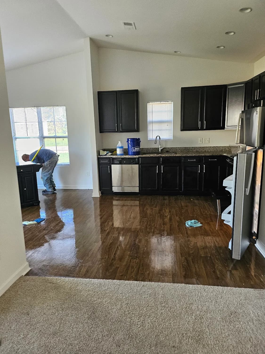 Wood floor cleaned and polished until it reflects the window light